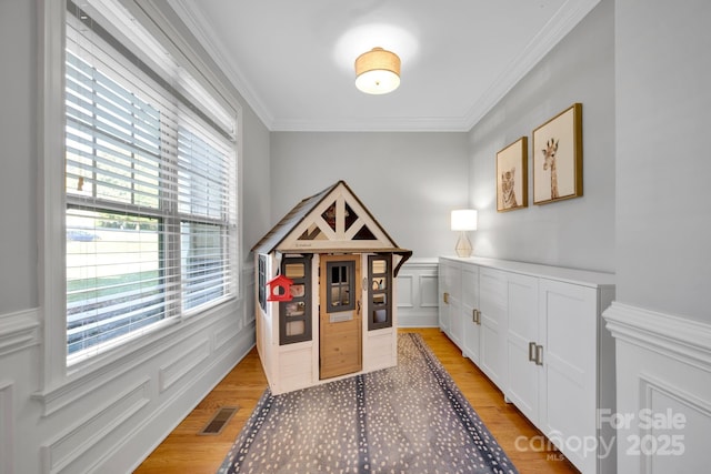 interior space featuring hardwood / wood-style flooring and ornamental molding