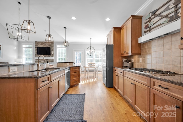 kitchen with black refrigerator, an inviting chandelier, decorative light fixtures, and sink