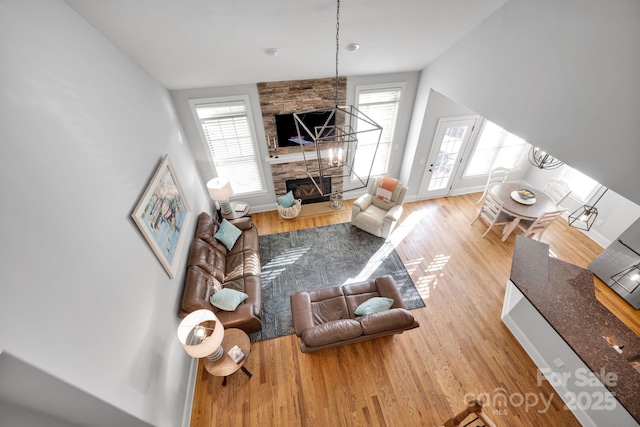 living room with hardwood / wood-style floors, a wealth of natural light, and a fireplace