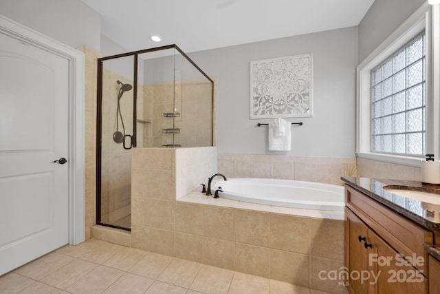 bathroom featuring plus walk in shower, tile patterned floors, and vanity