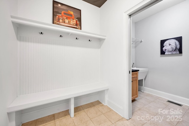 mudroom with light tile patterned flooring