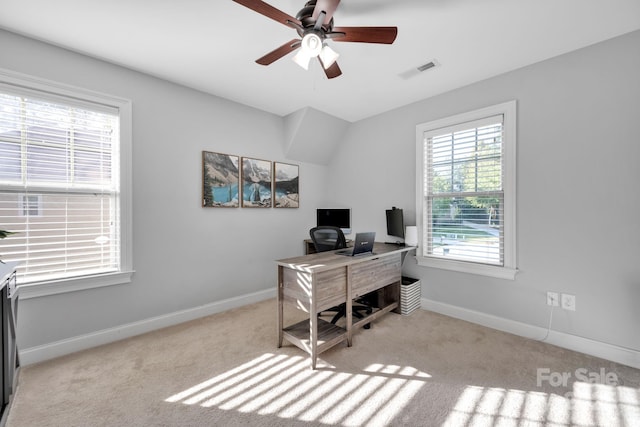 carpeted home office featuring ceiling fan