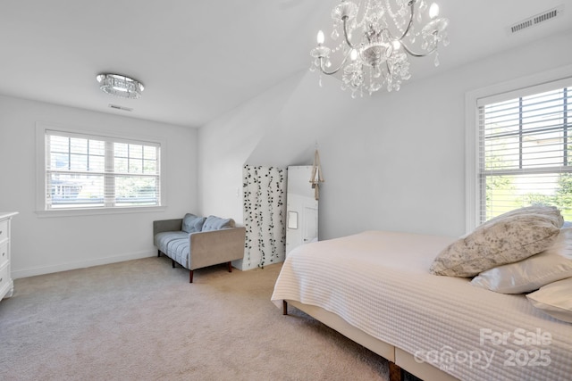 carpeted bedroom with an inviting chandelier