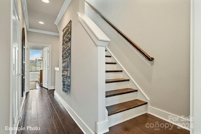 stairs featuring wood-type flooring and crown molding