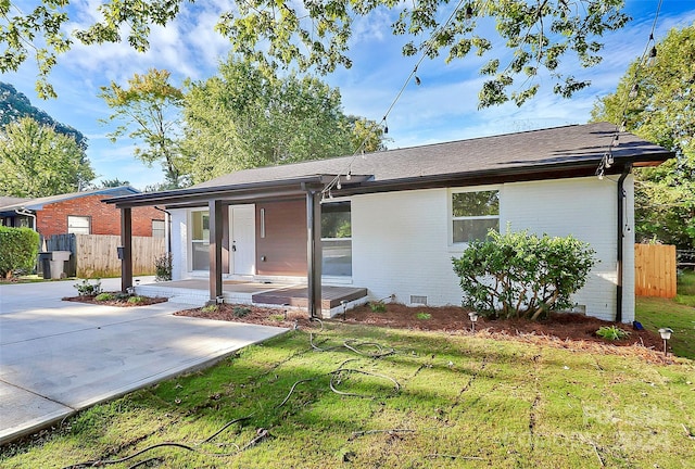 ranch-style home featuring a patio and a front yard