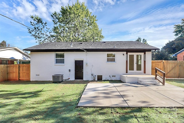 rear view of property with a patio and a lawn