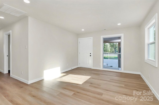 empty room featuring light hardwood / wood-style floors and a wealth of natural light