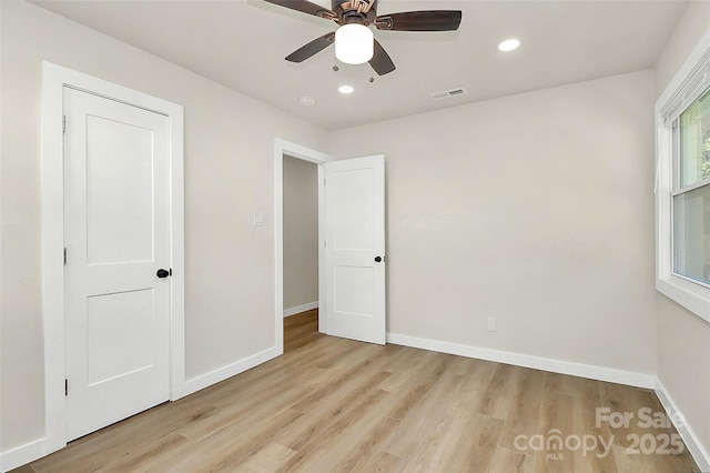 unfurnished bedroom with ceiling fan and light wood-type flooring