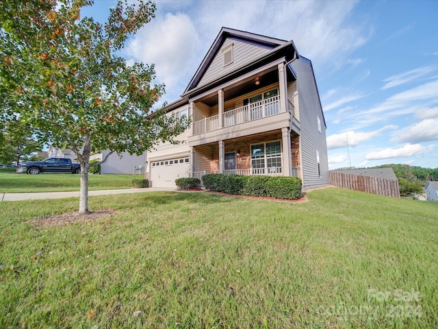 view of front of home featuring a balcony, a garage, and a front lawn