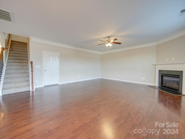 unfurnished living room with ornamental molding, dark wood-type flooring, and ceiling fan