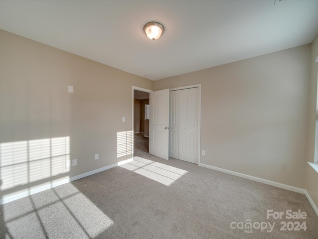 empty room featuring light colored carpet