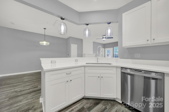 kitchen with white cabinetry, sink, hanging light fixtures, stainless steel dishwasher, and kitchen peninsula