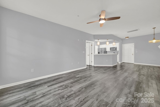 unfurnished living room featuring dark wood-type flooring and ceiling fan