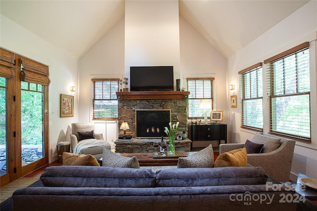 living room featuring a fireplace and high vaulted ceiling