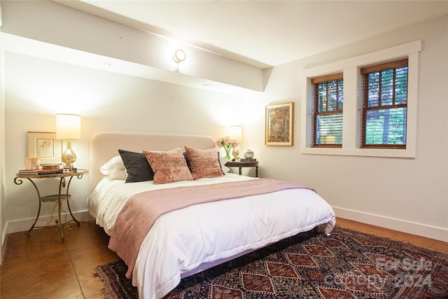 bedroom with dark tile patterned flooring