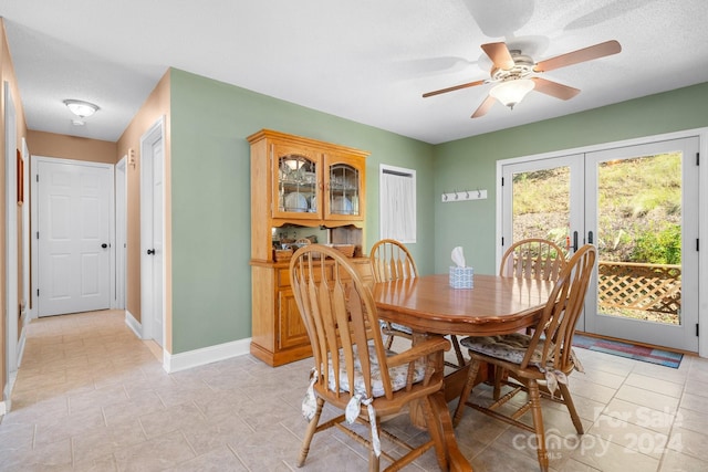 dining room with a textured ceiling, ceiling fan, and french doors