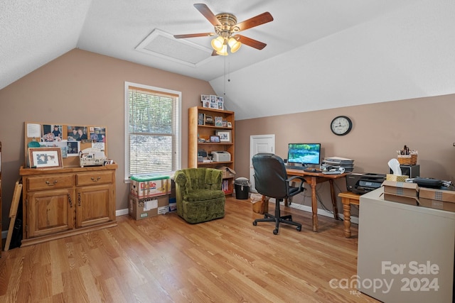 office space featuring ceiling fan, a textured ceiling, light wood-type flooring, and lofted ceiling