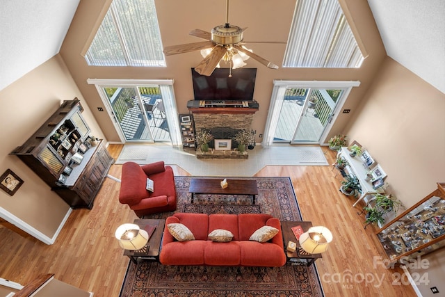 living room featuring high vaulted ceiling, hardwood / wood-style flooring, and a healthy amount of sunlight