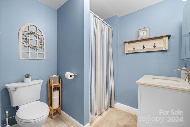 bathroom featuring walk in shower, tile patterned flooring, vanity, and toilet