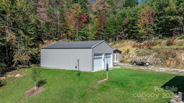 view of outdoor structure with a garage and a yard