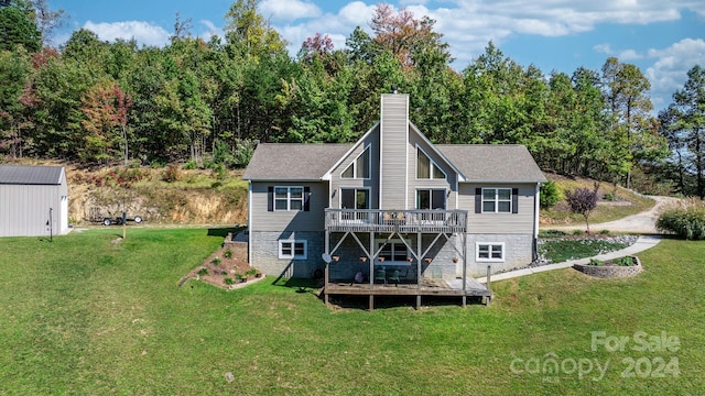 back of property with a lawn, an outdoor structure, and a deck