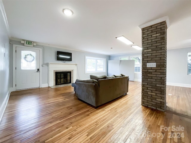 living room with light hardwood / wood-style flooring and ornamental molding