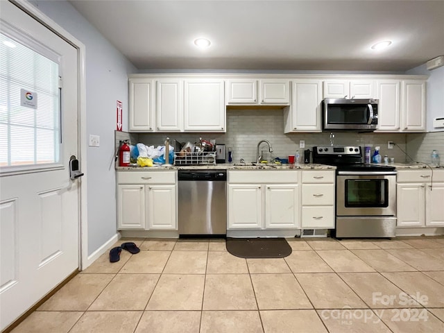 kitchen featuring white cabinets, stainless steel appliances, and sink