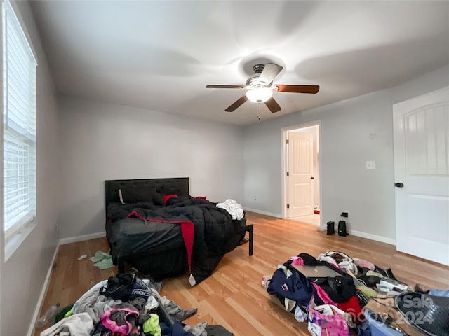 bedroom with ceiling fan and hardwood / wood-style flooring