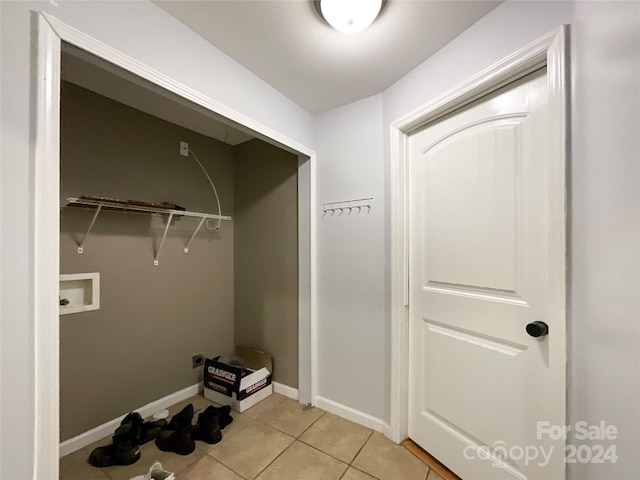 laundry area with light tile patterned flooring