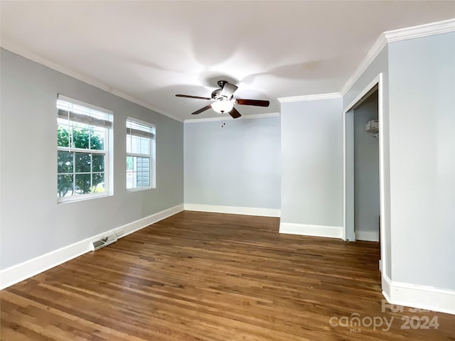 spare room featuring ornamental molding, dark hardwood / wood-style flooring, and ceiling fan