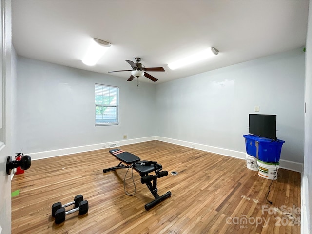 workout area with wood-type flooring and ceiling fan