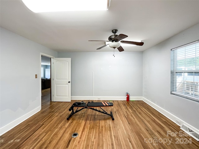 workout area with hardwood / wood-style floors and ceiling fan