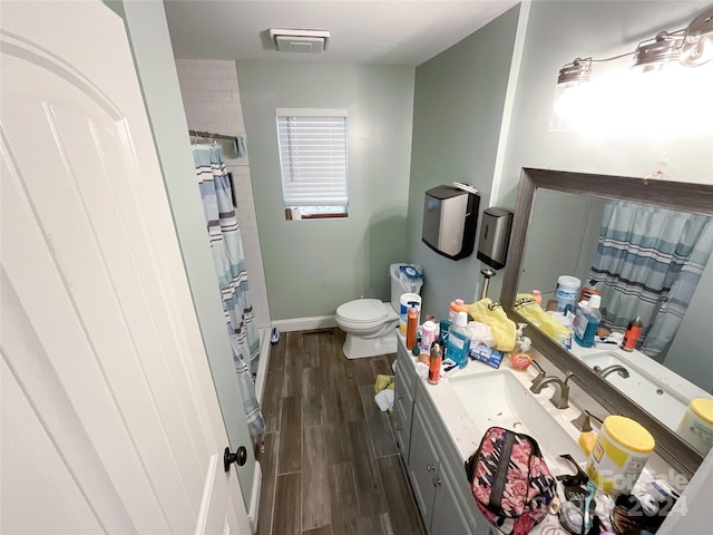 bathroom featuring wood-type flooring, vanity, toilet, and a shower with shower curtain