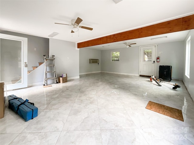 living room featuring an AC wall unit and ceiling fan