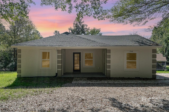 view of back house at dusk