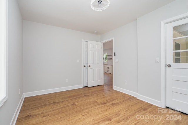 spare room with light hardwood / wood-style flooring