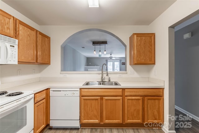 kitchen featuring ceiling fan, white appliances, decorative light fixtures, and sink