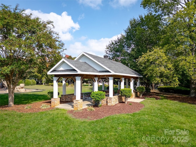 view of property's community with a gazebo and a yard