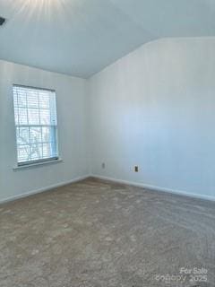 spare room with vaulted ceiling