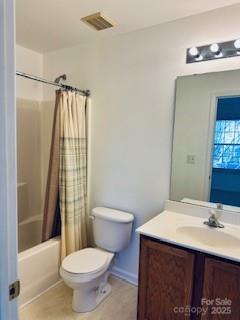 full bathroom featuring vanity, shower / tub combo, and toilet