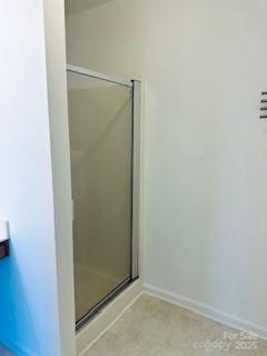 bathroom with a shower with door