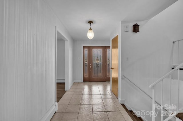 entryway with baseboard heating and light tile patterned floors