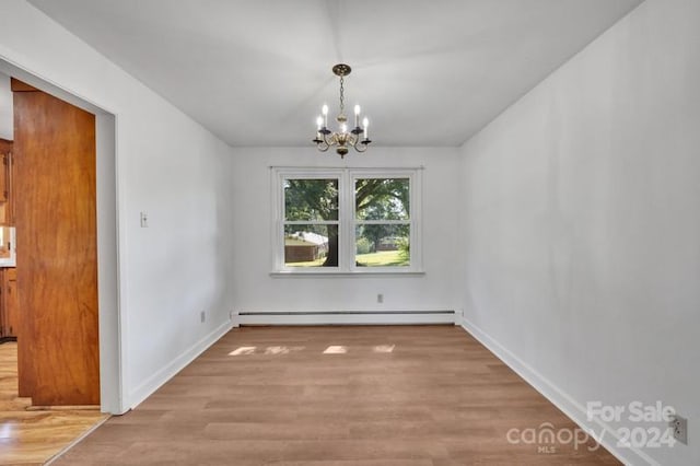 unfurnished dining area with light wood-type flooring, an inviting chandelier, and a baseboard radiator