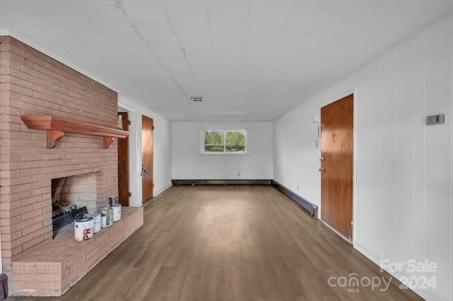 unfurnished living room featuring hardwood / wood-style flooring and a fireplace