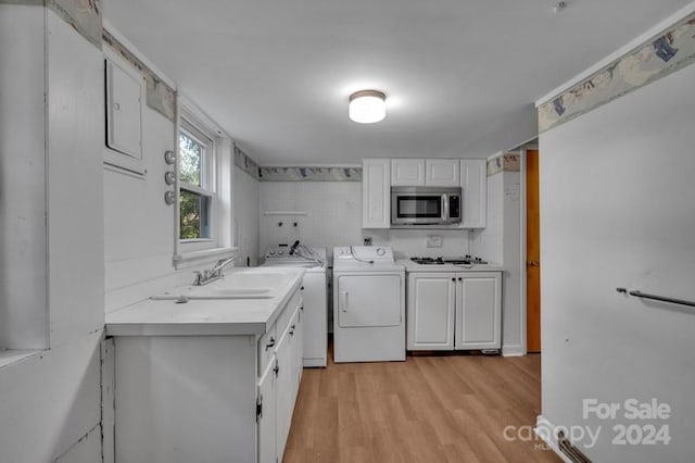 washroom featuring light hardwood / wood-style floors, sink, and independent washer and dryer