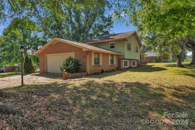 view of side of home featuring a lawn and a garage