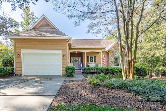 view of front of home with a porch and a garage