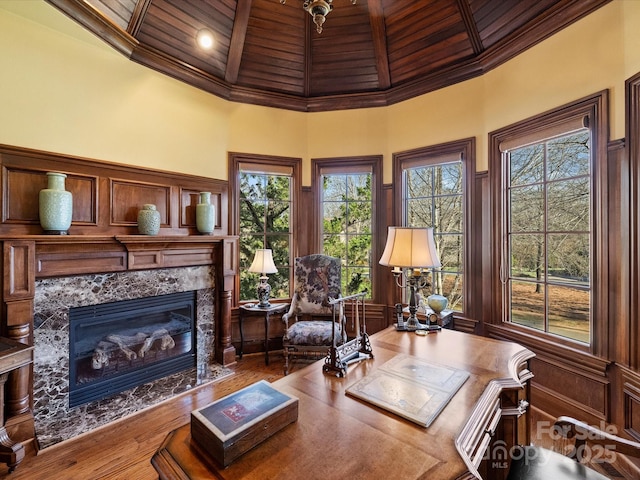 home office featuring a premium fireplace, wooden ceiling, a towering ceiling, and plenty of natural light