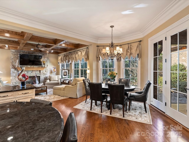 dining room with an inviting chandelier, ornamental molding, beam ceiling, and coffered ceiling