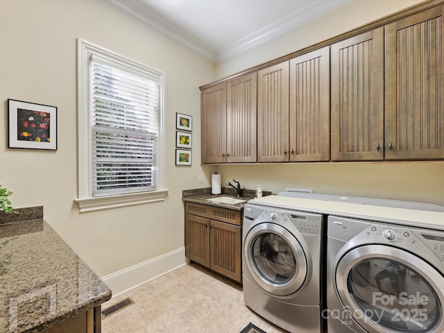 washroom featuring cabinets, sink, independent washer and dryer, light tile patterned flooring, and crown molding